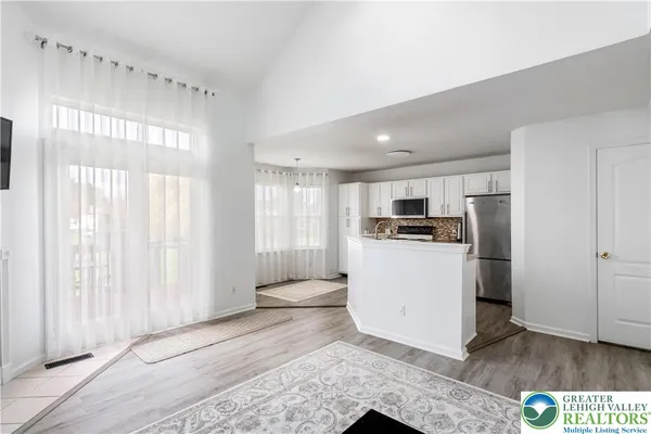 a view of kitchen with refrigerator and window