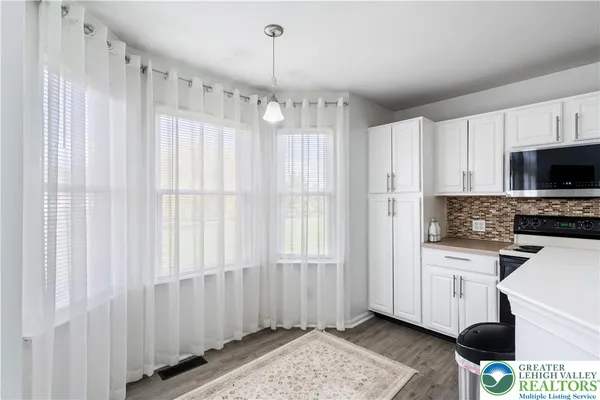 a kitchen with a refrigerator a stove a microwave and cabinets