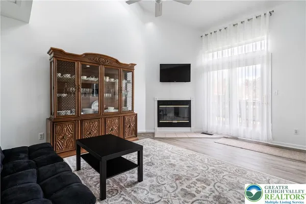 a living room with furniture a flat screen tv and a fireplace