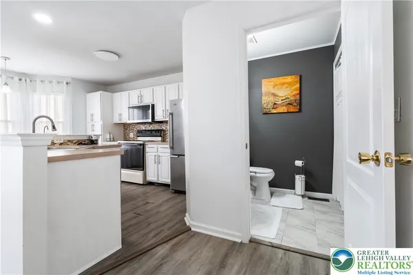 a kitchen with a refrigerator sink and cabinets