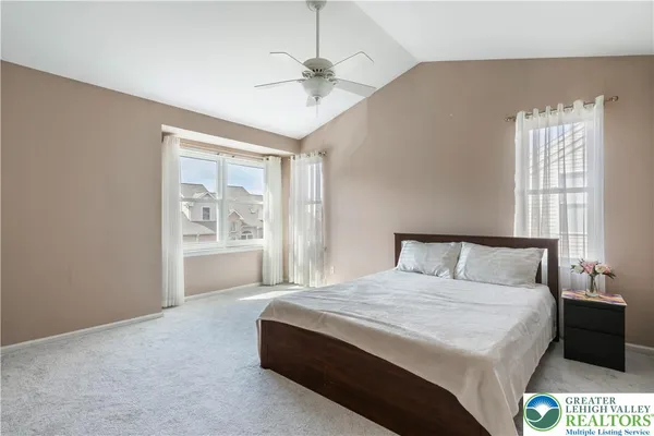 a spacious bedroom with a bed and a window