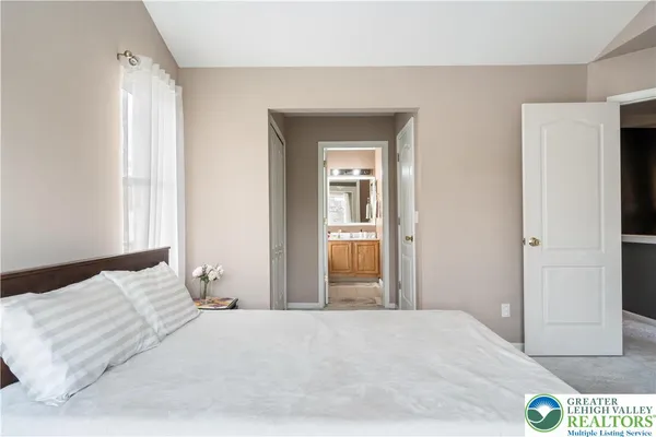 a bedroom with a bed and a mirror