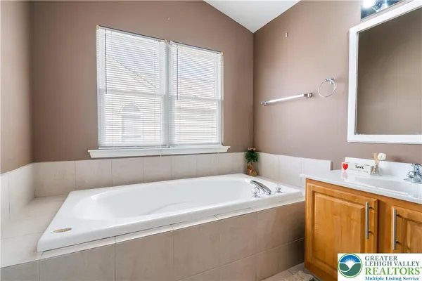 a bathroom with a bathtub and a window