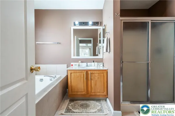 a bathroom with a tub and sink