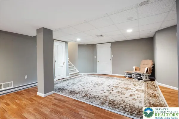 a view of a bedroom with wooden floor and bedroom