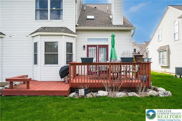 a view of a house with a yard and deck