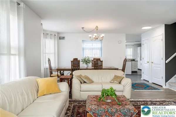 a living room with furniture and a chandelier