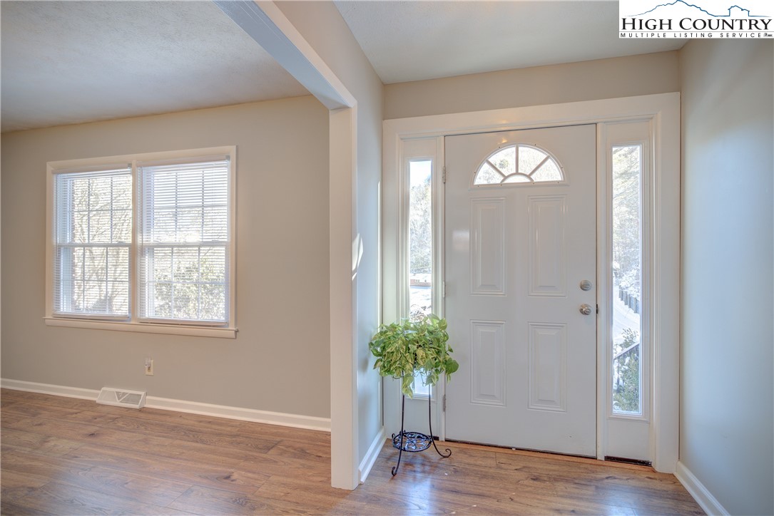 142 Edna Street Boone, NC 28607 - Photo 4 of 31 an empty room with wooden floor and windows