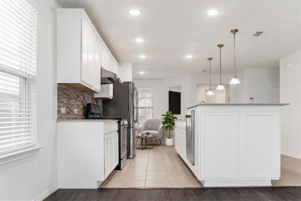 7793 Gulf Walk Road Frisco, TX 75036 - Photo 11 of 37 a kitchen with stainless steel appliances granite countertop a refrigerator a oven and a wooden floors