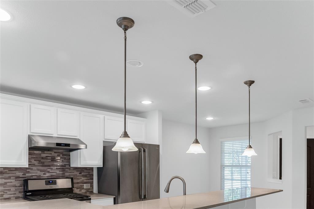 7793 Gulf Walk Road Frisco, TX 75036 - Photo 16 of 37 a kitchen with refrigerator and chairs