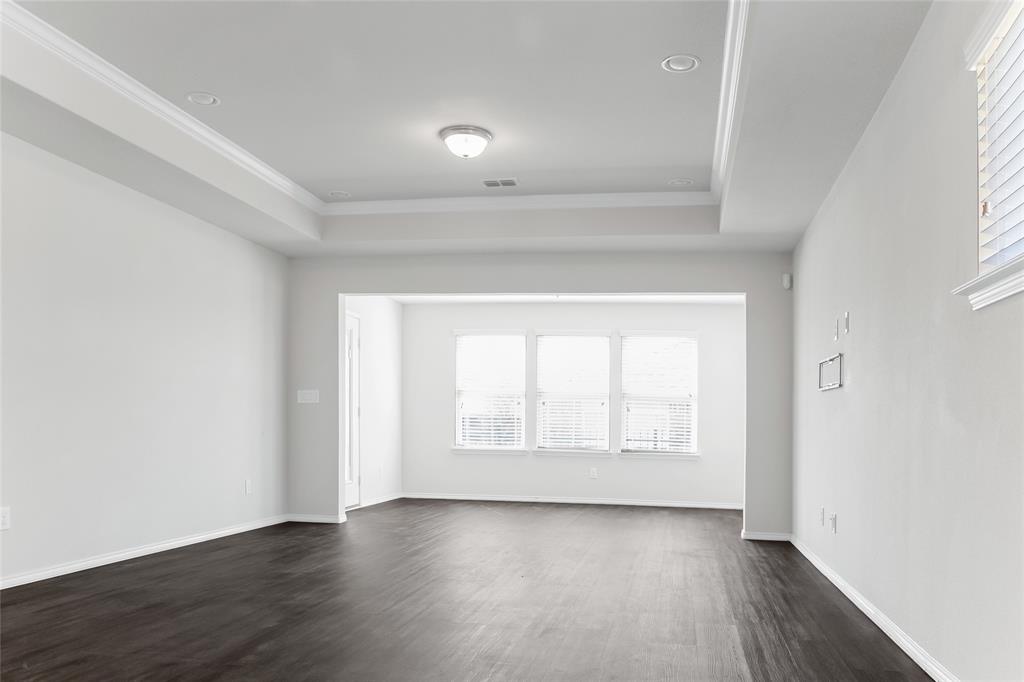 7793 Gulf Walk Road Frisco, TX 75036 - Photo 18 of 37 an empty room with wooden floor and windows