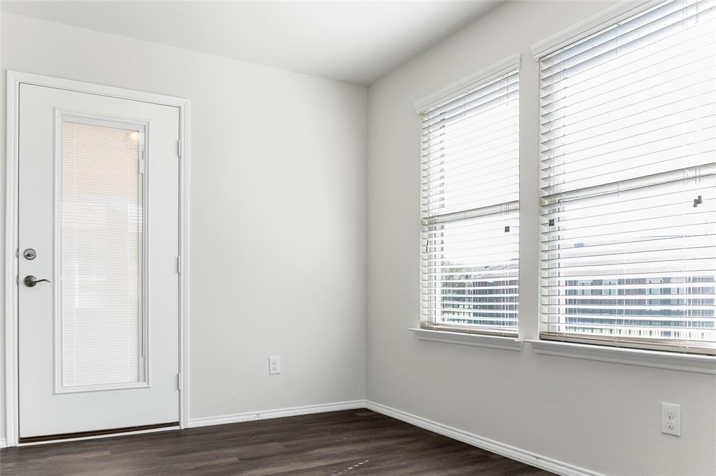 7793 Gulf Walk Road Frisco, TX 75036 - Photo 22 of 37 a view of an empty room with wooden floor and a window
