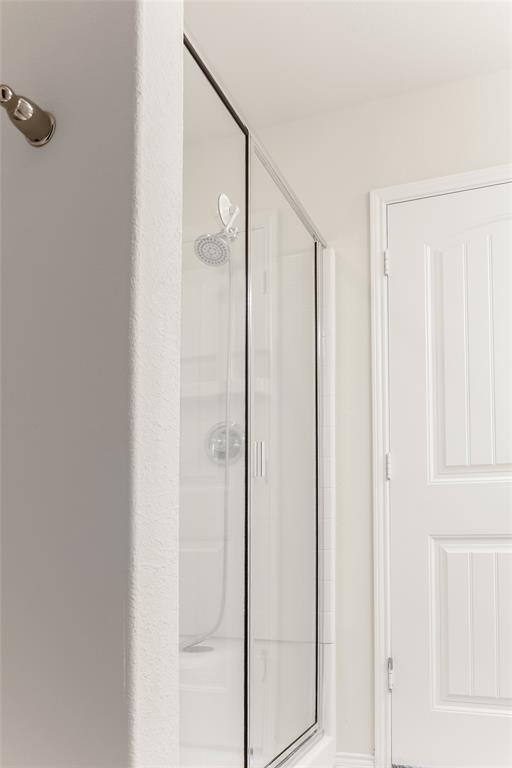 7793 Gulf Walk Road Frisco, TX 75036 - Photo 31 of 37 a bathroom with a shower and a glass door