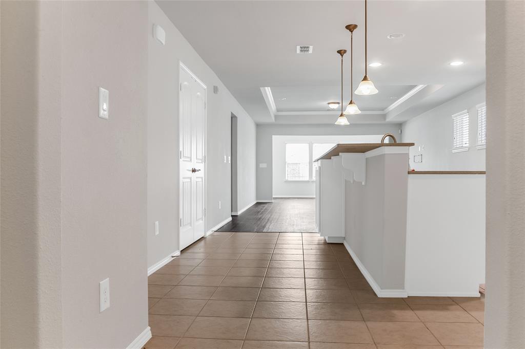 7793 Gulf Walk Road Frisco, TX 75036 - Photo 6 of 37 a view of a hallway with a chandelier