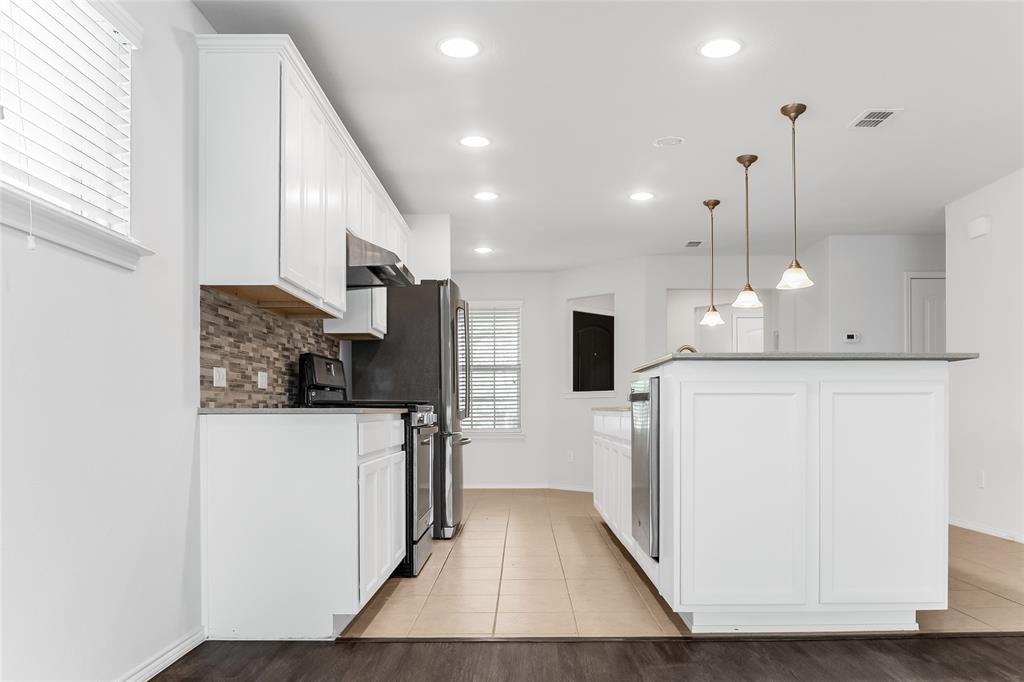 7793 Gulf Walk Road Frisco, TX 75036 - Photo 10 of 37 a kitchen with refrigerator and a wooden floor