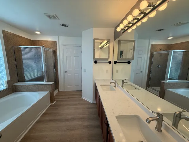 a large bathroom with a double vanity sink and a large mirror