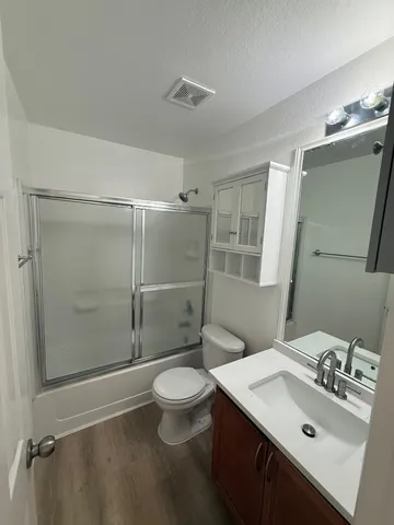 a bathroom with a sink a large mirror and shower