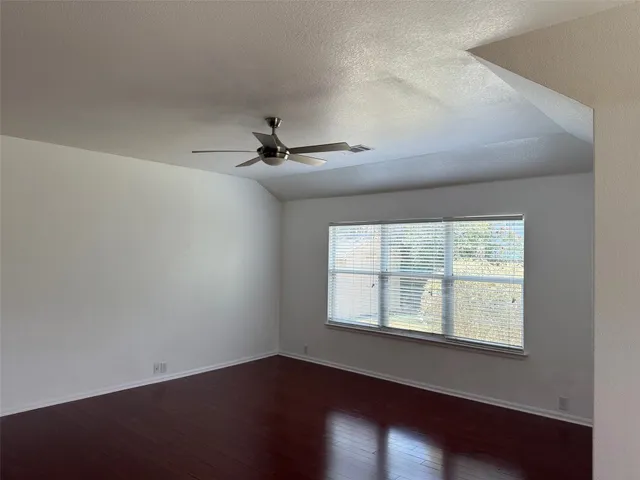 a view of entryway and kitchen with wooden floor