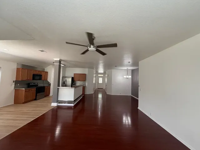 a view of a kitchen with cabinets and wooden floor