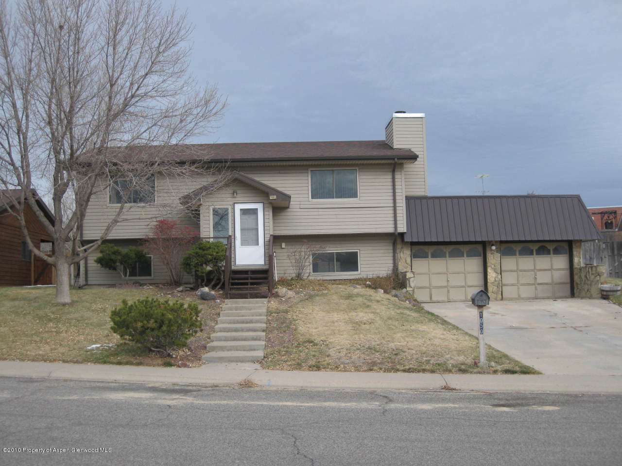 1050 Fir Avenue Rifle, CO 81650 - Photo 1 of 6 a front view of a house with garden