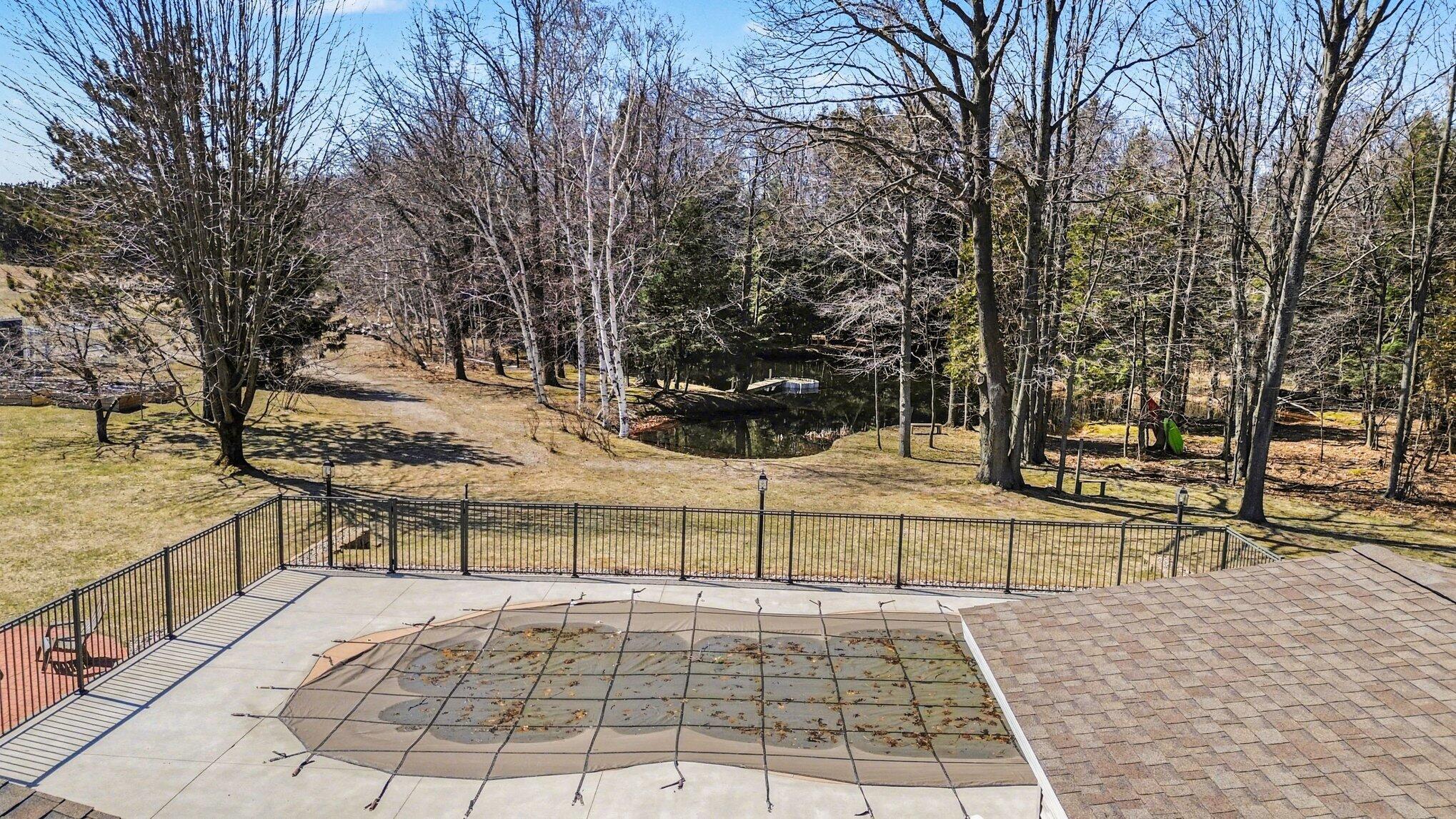 4786 Red Apple Road Manistee, MI 49660 - Photo 32 of 41 Back patio with in ground pool