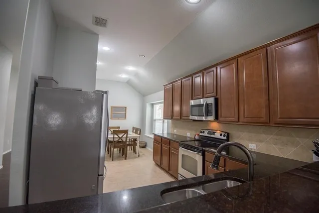 a kitchen with a table and chairs