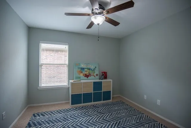 a view of a house with a yard and potted plants