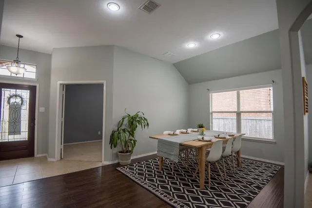 a dining room with furniture and wooden floor