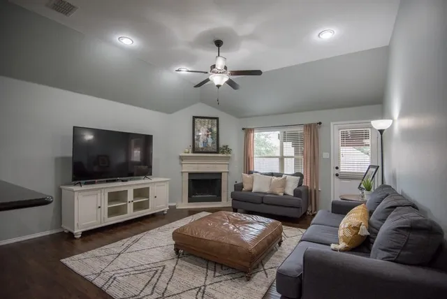 a living room with furniture and a fireplace