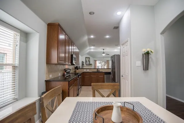 a kitchen with stainless steel appliances granite countertop a refrigerator stove and microwave