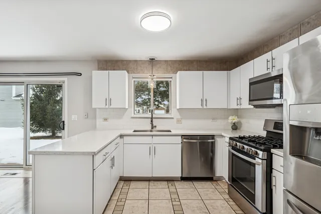 a kitchen with a sink stove and microwave