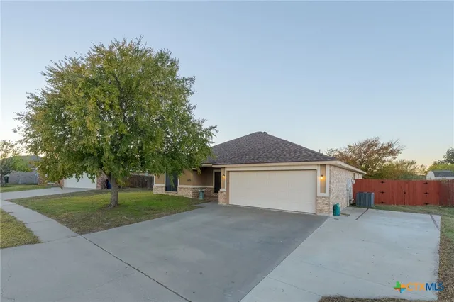 a front view of a house with a yard and a garage