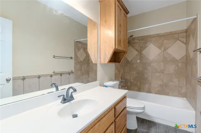 a bathroom with a sink a toilet and a bathtub