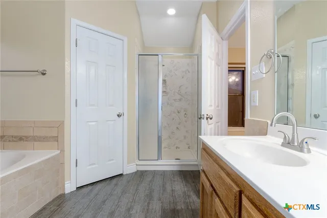 a bathroom with a sink and a mirror with bathtub