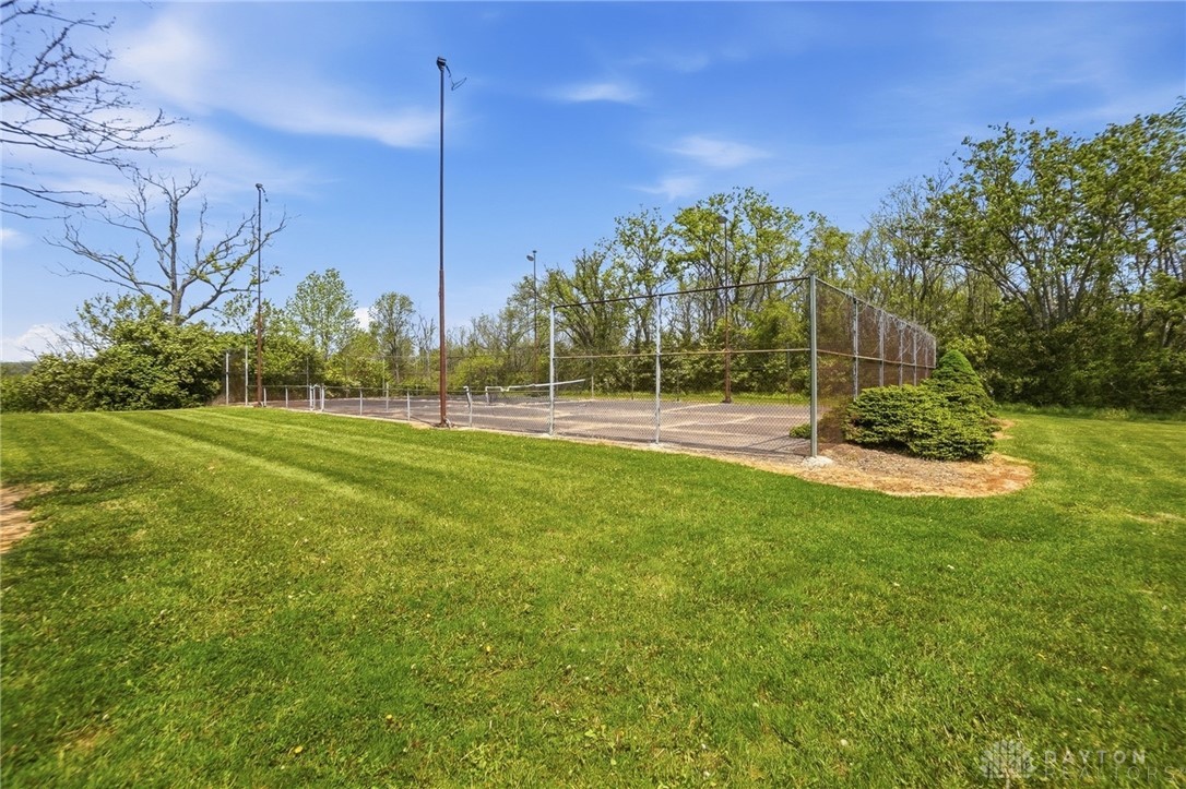 5669 O Neall Road Waynesville, OH 45068 - Photo 50 of 72 Enjoy outdoor recreation with this spacious, well-maintained tennis court, set amidst lush green landscaping.