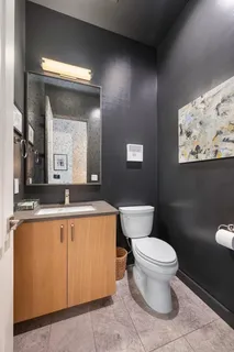 a bathroom with a sink a toilet a mirror and vanity