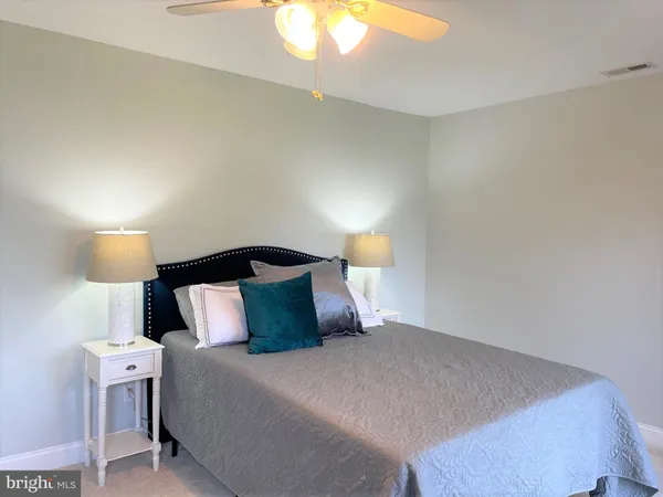 a blue bed sitting in a bedroom next to a window