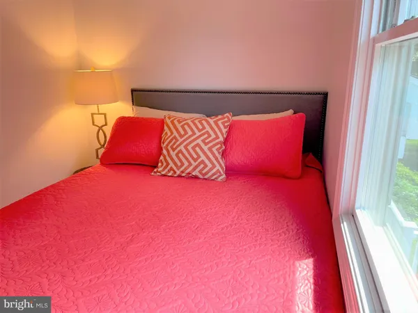 a bedroom with a bed and a chair