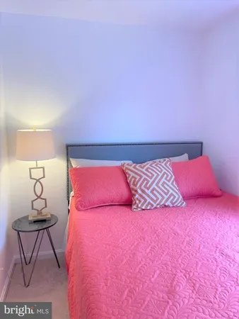 a bedroom with a bed and lamp