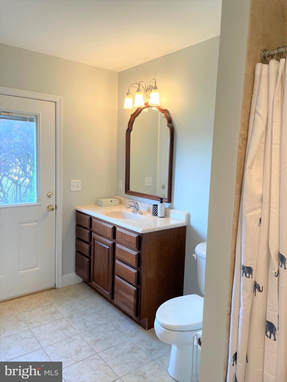 226 Bentons Pleasure Road Chester, MD 21619 - Photo 36 of 49 a bathroom with a toilet sink and mirror