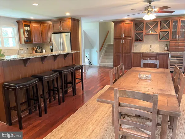 a kitchen with kitchen island granite countertop a stove a sink and a refrigerator