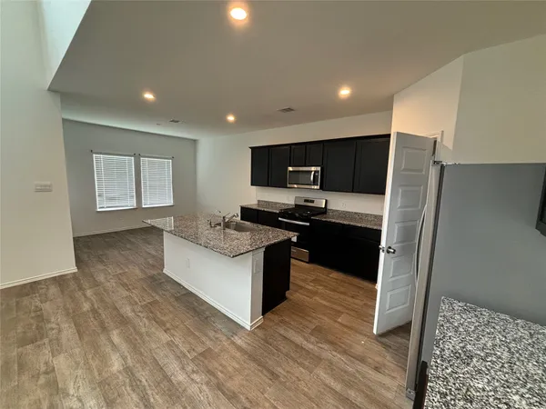 a kitchen with a sink and a mirror