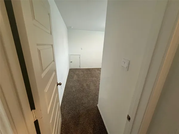 an empty room with closet and windows