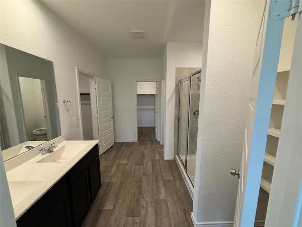 a bathroom with a shower and a glass door