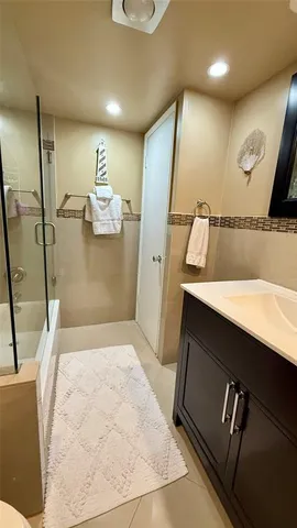 a white toilet sitting next to a bath tub and a shower