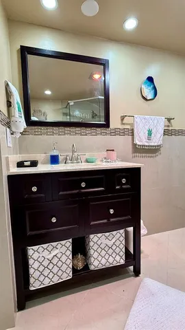 a room with furniture and a flat tv screen on dresser