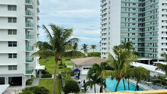 a view of swimming pool with outdoor seating and plants