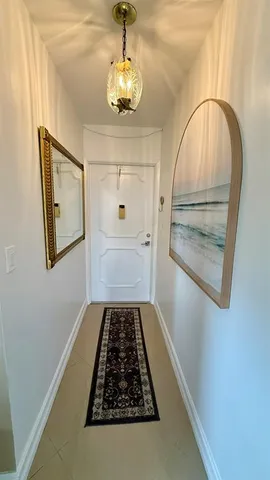 a view of a kitchen with stainless steel appliances granite countertop a sink and a refrigerator