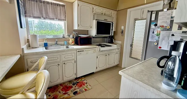 a kitchen with stainless steel appliances a refrigerator and a stove