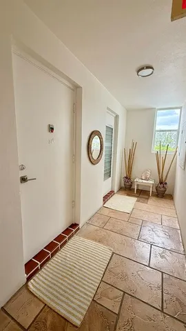 a view of a balcony with a chair and a fireplace